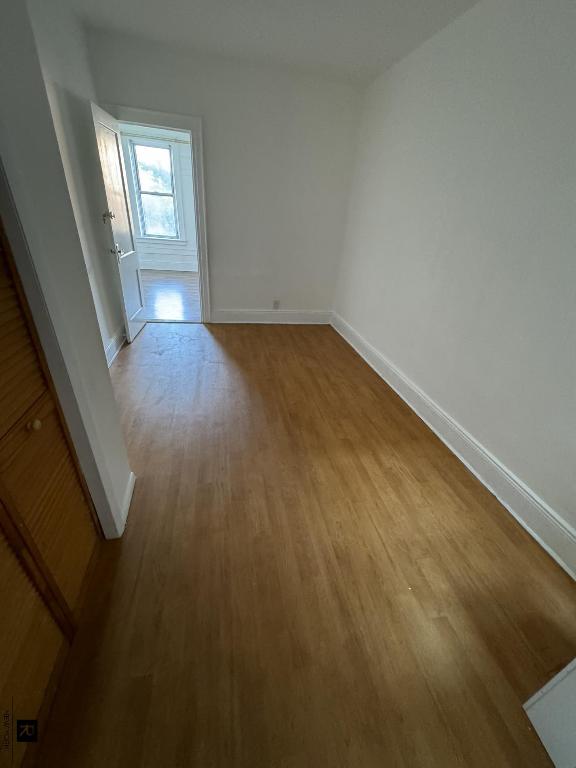 spare room with light wood-style flooring and baseboards