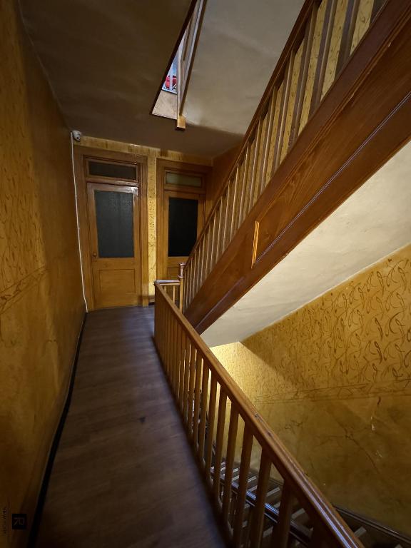 hall with stairs and dark wood-type flooring