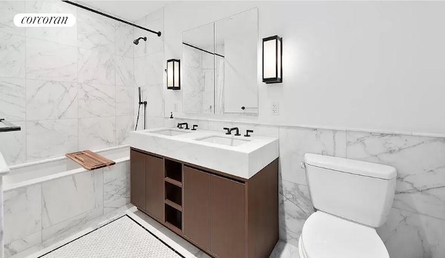 full bathroom featuring tiled shower / bath combo, vanity, and toilet