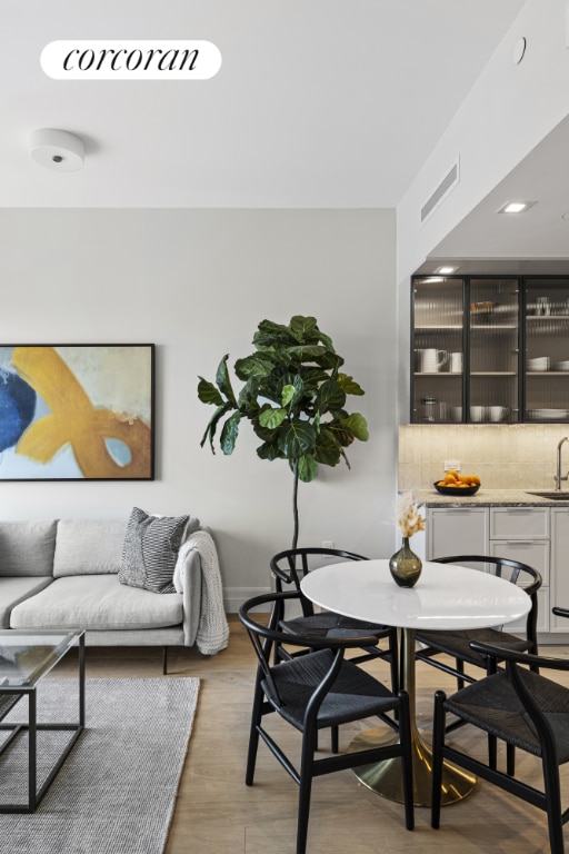 dining space featuring hardwood / wood-style flooring and sink