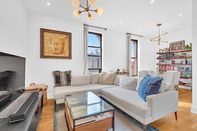 living room featuring a chandelier, light wood-style flooring, and recessed lighting