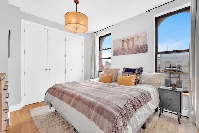 bedroom featuring light wood-type flooring and a closet