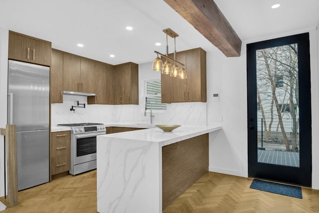 kitchen with sink, decorative light fixtures, stainless steel appliances, and light parquet flooring