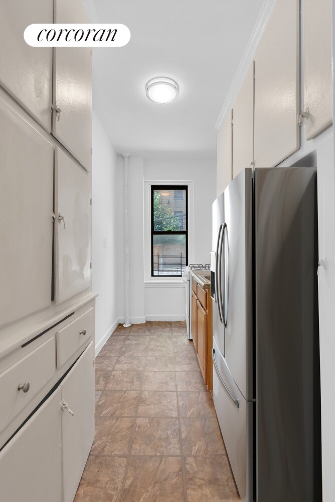 kitchen featuring stainless steel refrigerator with ice dispenser and white cabinets