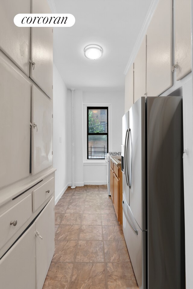 kitchen featuring stainless steel refrigerator with ice dispenser and white cabinets