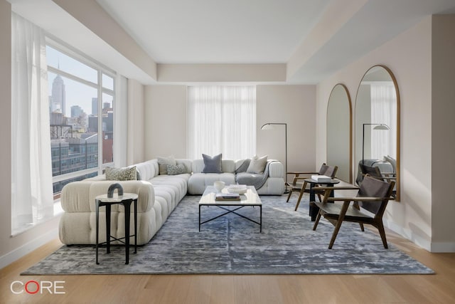 555 W 22nd St Unit Ph16Be, New York City, NY 10011 - living area with baseboards, wood finished floors, a tray ceiling, and a view of city