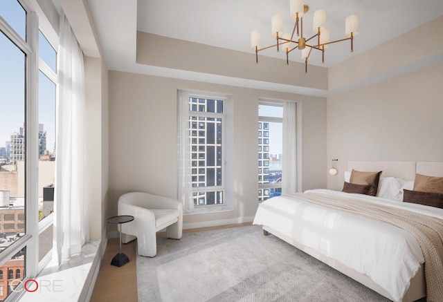 555 W 22nd St Unit Ph16Be, New York City, NY 10011 - bedroom with a chandelier, baseboards, access to exterior, and a view of city