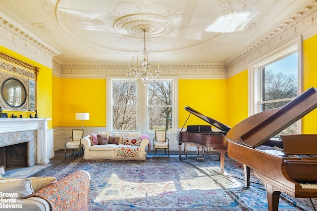 living area with a high end fireplace, ornamental molding, and a notable chandelier