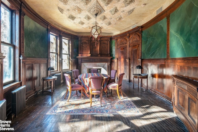 sitting room with dark wood-type flooring and radiator heating unit