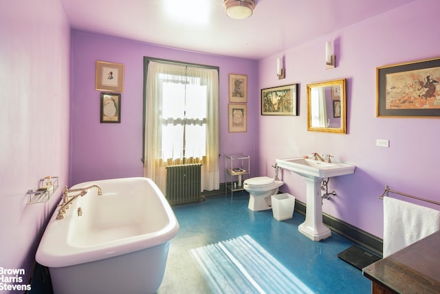 bathroom featuring radiator, toilet, and a washtub