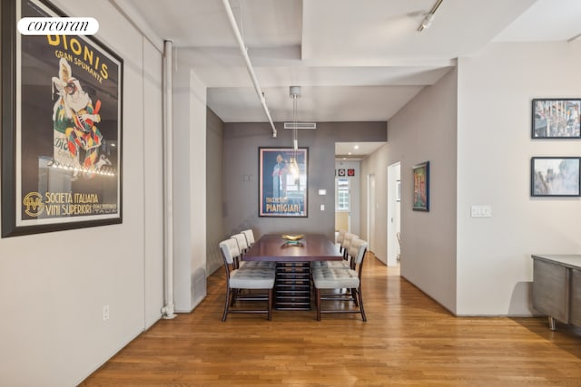 dining room featuring track lighting and light hardwood / wood-style floors