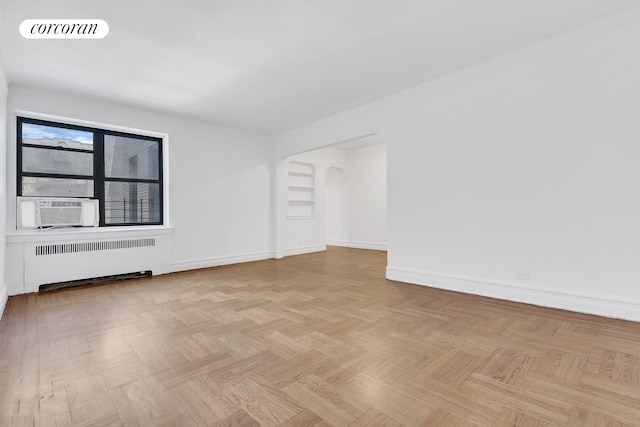 spare room with radiator, baseboards, visible vents, and cooling unit