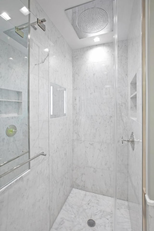 full bath featuring a marble finish shower