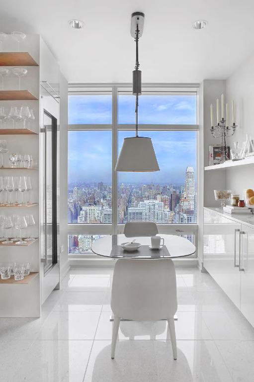 dining space with expansive windows and light tile patterned floors