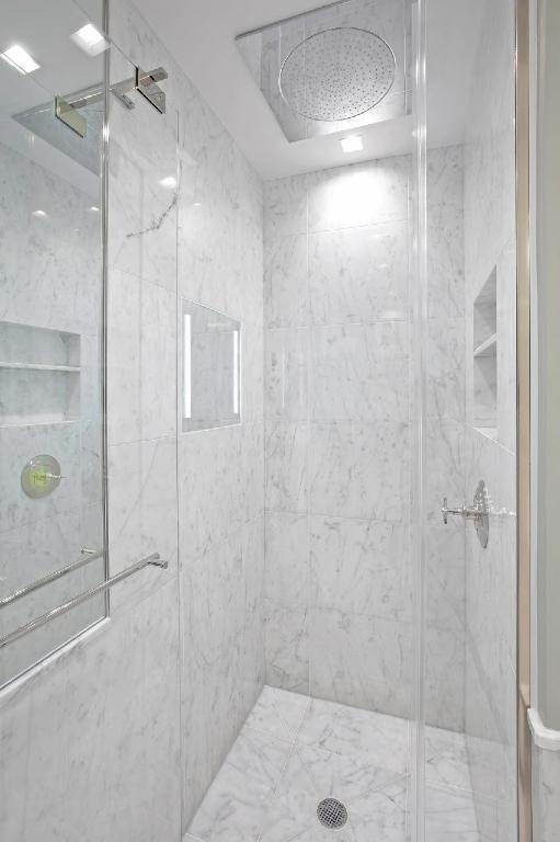 bathroom with a shower with shower door