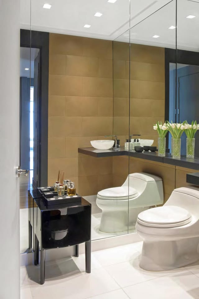 bathroom featuring tile walls, toilet, and tile patterned floors