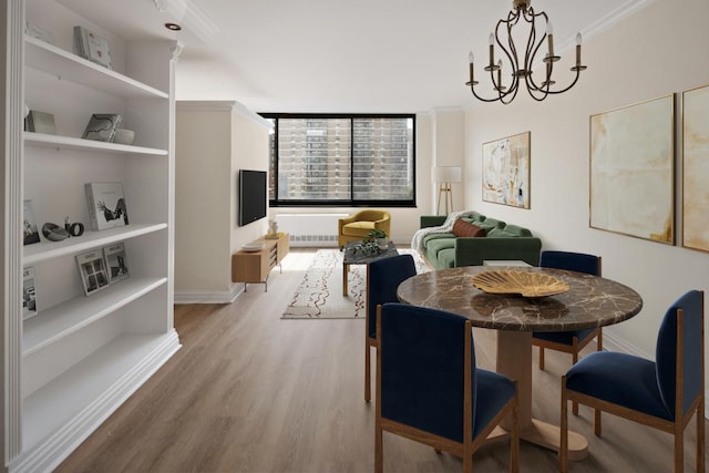 dining space with an inviting chandelier and light hardwood / wood-style flooring