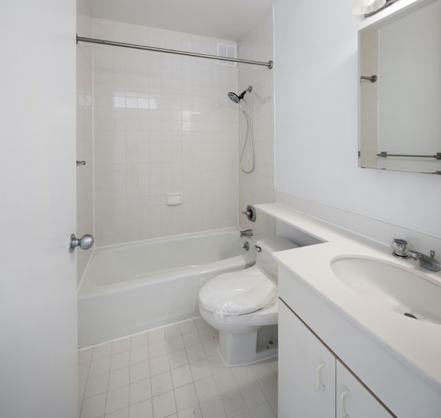 full bathroom featuring vanity, tile patterned flooring, tiled shower / bath combo, and toilet