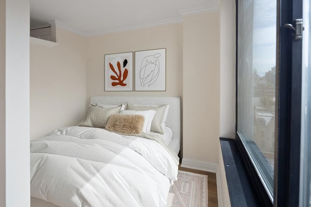 bedroom with crown molding and dark wood-type flooring