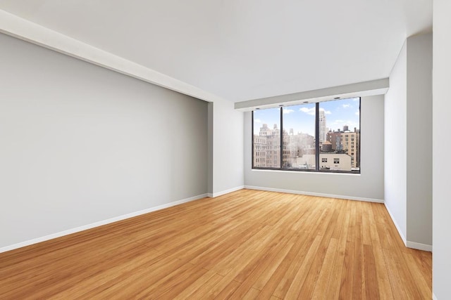 unfurnished room with light wood-type flooring