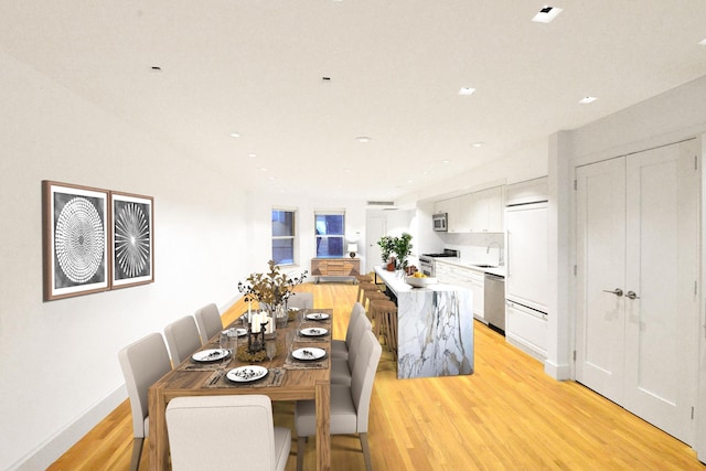 dining room with light wood-style flooring, recessed lighting, and baseboards