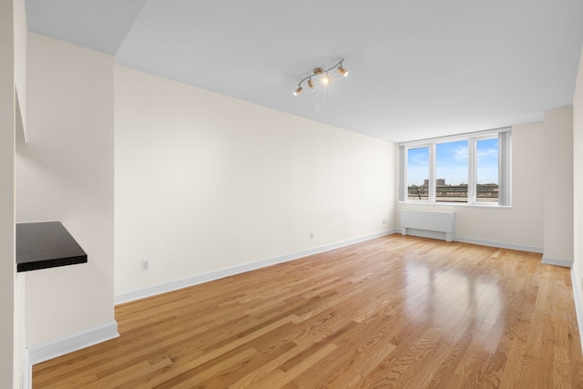 120 Riverside Blvd Unit 5-H, New York City, NY 10069 - unfurnished living room with light wood-style floors and baseboards