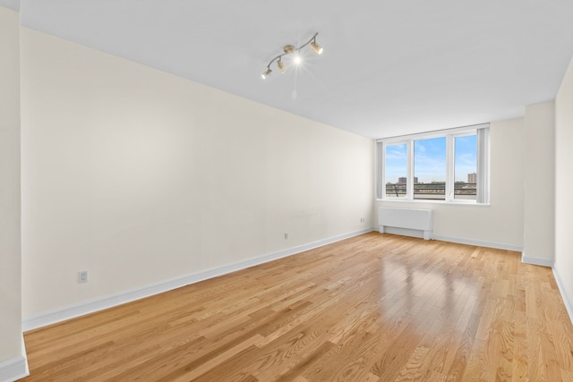 120 Riverside Blvd Unit 5-H, New York City, NY 10069 - unfurnished room with light wood finished floors, baseboards, and rail lighting