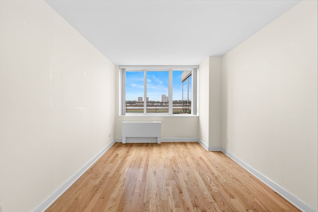 120 Riverside Blvd Unit 5-H, New York City, NY 10069 - unfurnished room featuring radiator heating unit, light wood-type flooring, and baseboards