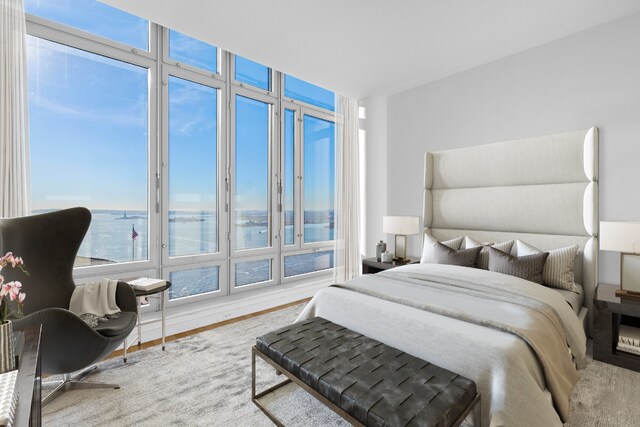 bedroom featuring a water view, wood-type flooring, and a chandelier