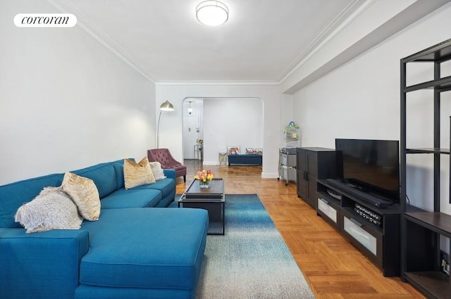 living room with baseboards, visible vents, and crown molding