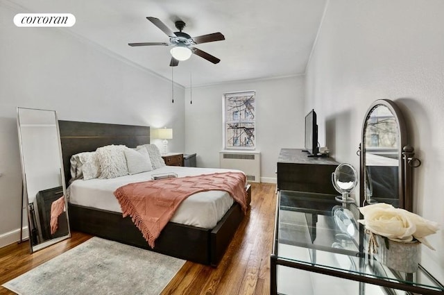 bedroom with baseboards, dark wood finished floors, visible vents, and radiator