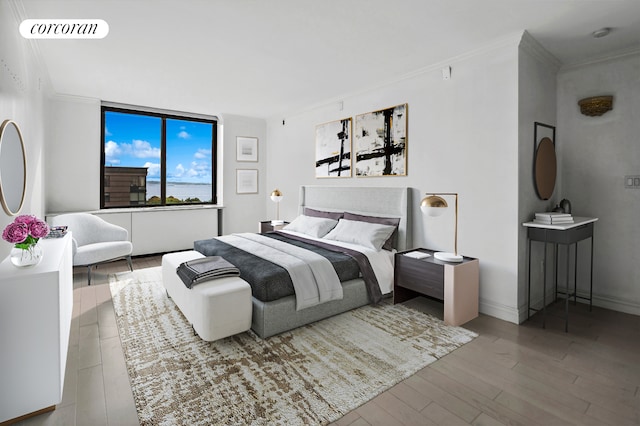 bedroom with baseboards, wood finished floors, visible vents, and crown molding