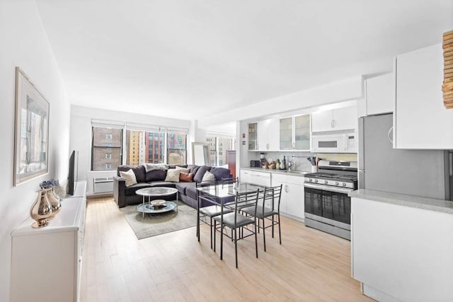 dining room with sink and light hardwood / wood-style flooring