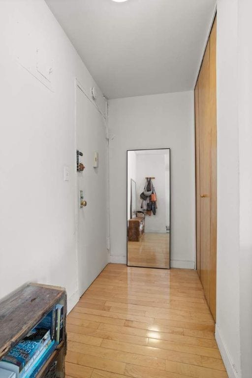 hallway with light hardwood / wood-style flooring