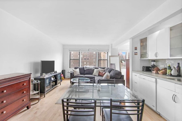 dining room featuring sink and light hardwood / wood-style floors