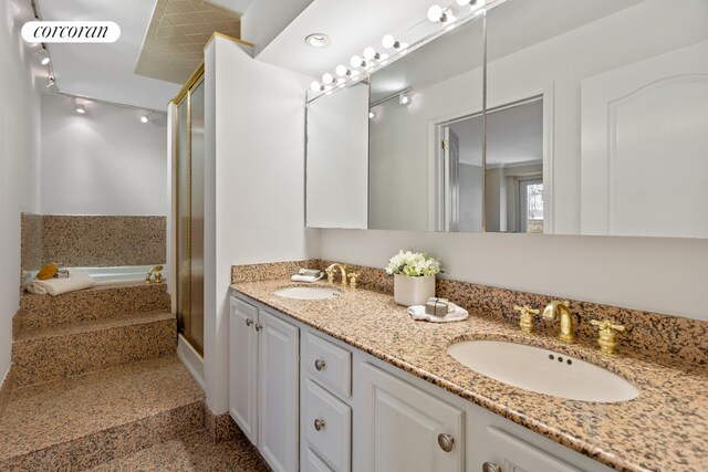 bathroom featuring independent shower and bath and vanity