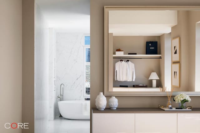 bathroom with a tub to relax in