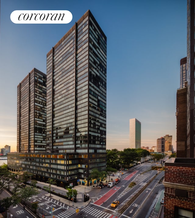 property at dusk featuring a city view