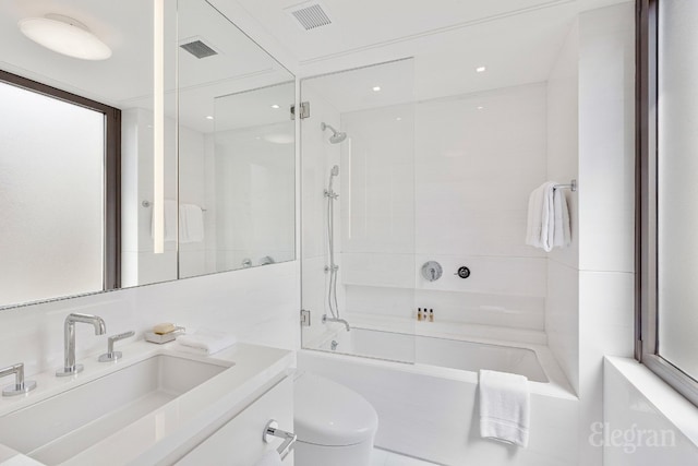 full bathroom featuring shower / bath combination with glass door, vanity, and toilet