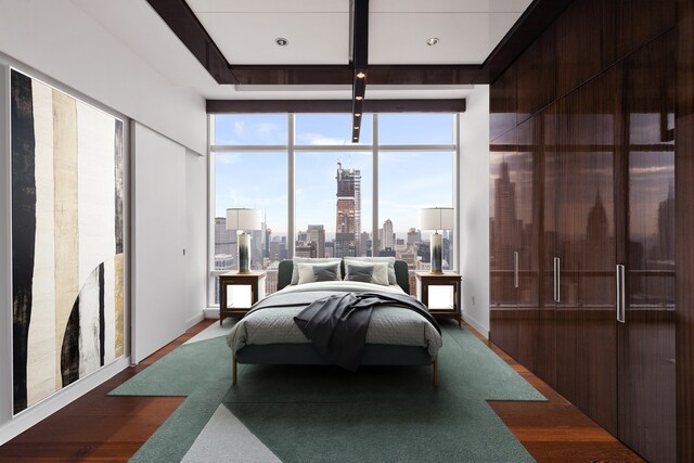 bedroom featuring hardwood / wood-style flooring and a wall of windows