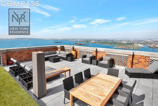 view of patio featuring a water view, a beach view, and outdoor lounge area