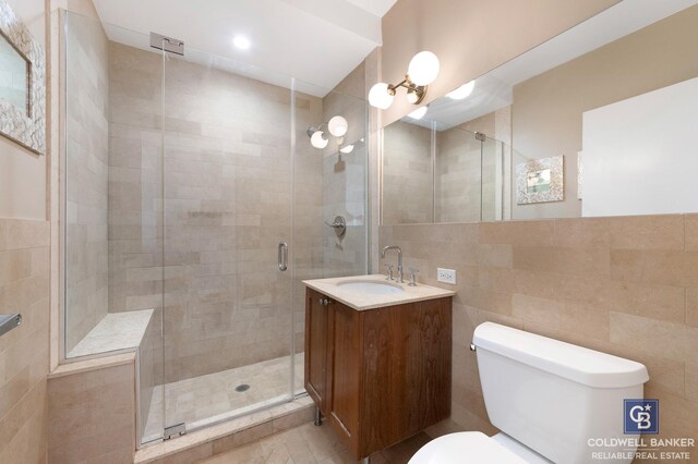 full bathroom with tiled shower / bath combo, vanity, tile walls, and toilet