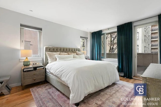 bedroom featuring hardwood / wood-style flooring and multiple windows