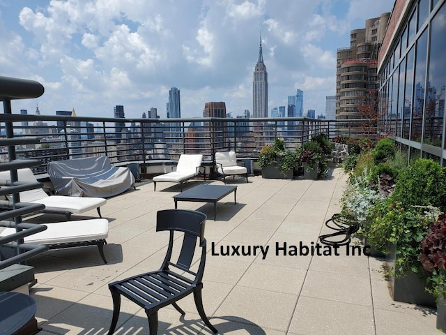 view of patio / terrace featuring a balcony and a view of city