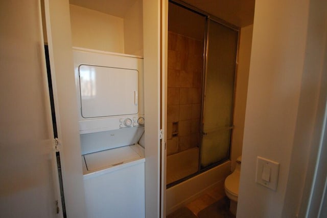 laundry area featuring stacked washing maching and dryer