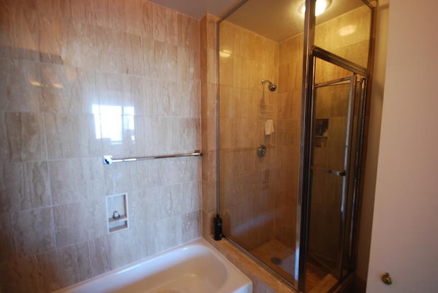 full bath with a garden tub and a stall shower