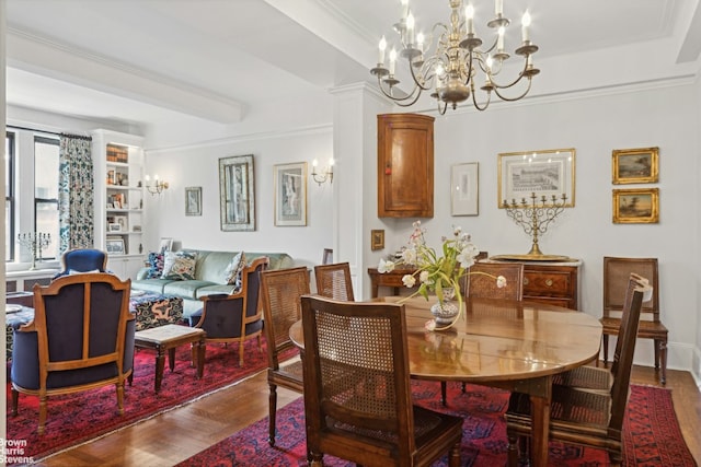 dining room with parquet floors, ornamental molding, and a chandelier