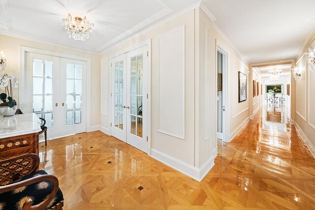 bedroom with crown molding, light parquet flooring, and a chandelier