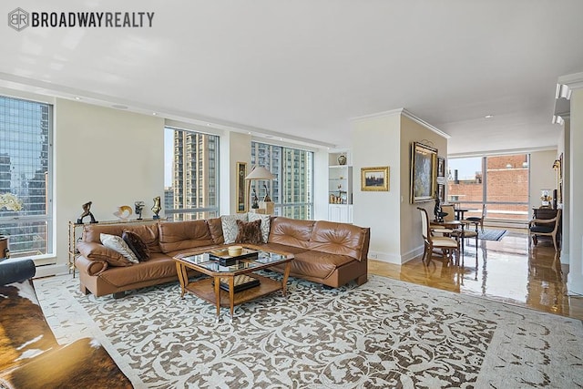 living room featuring a wealth of natural light, ornamental molding, and a wall of windows