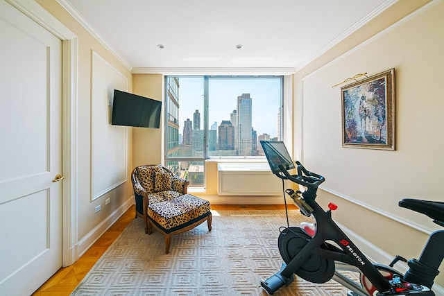 workout room with baseboards and crown molding